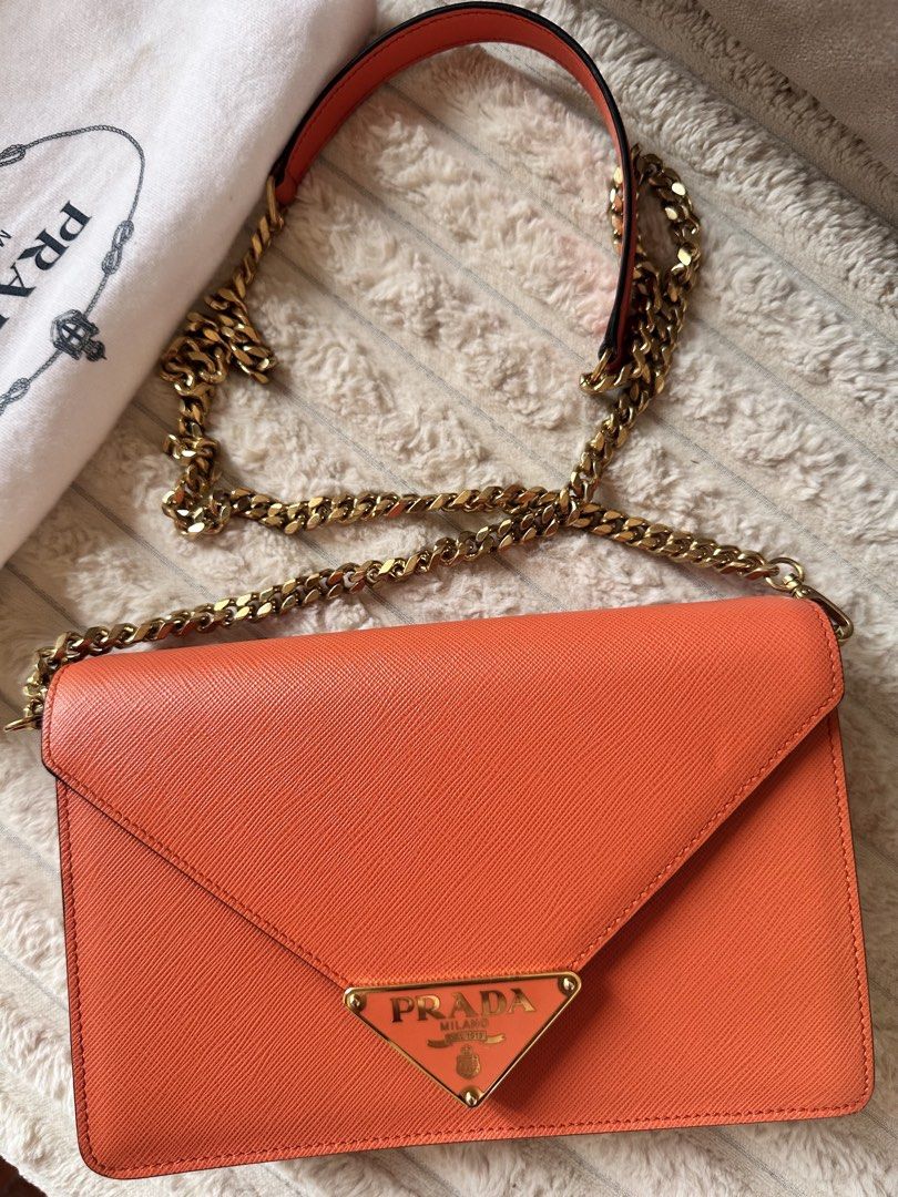 Prada Orange Saffiano Leather Wallet and Chain Bag Set (Category: Luxury Bags & Wallets) located in Paranaque City. Submitted by pamsilog (Listing ID 1463804329, Image 3). Description: - Authentic Prada Wallet & Chain Bag Set - Vibrant Orange Saffiano Leather - Chain bag features a stylish gold chain strap - Wallet includes convenient card slots - Comes with original Prada dust bag and box Paper Bag - Ideal for gifting or a personal treat BOUGHT 