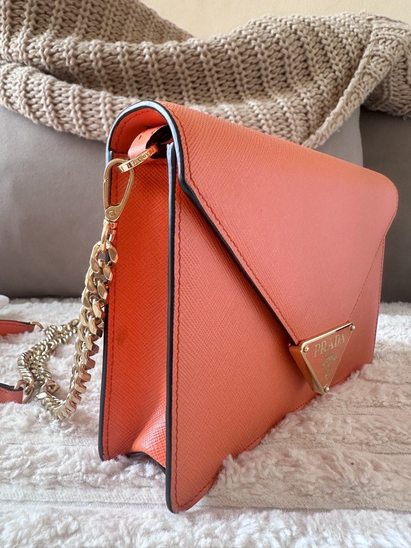 Prada Orange Saffiano Leather Wallet and Chain Bag Set (Category: Luxury Bags & Wallets) located in Paranaque City. Submitted by pamsilog (Listing ID 1463804329, Image 1). Description: - Authentic Prada Wallet & Chain Bag Set - Vibrant Orange Saffiano Leather - Chain bag features a stylish gold chain strap - Wallet includes convenient card slots - Comes with original Prada dust bag and box Paper Bag - Ideal for gifting or a personal treat BOUGHT 