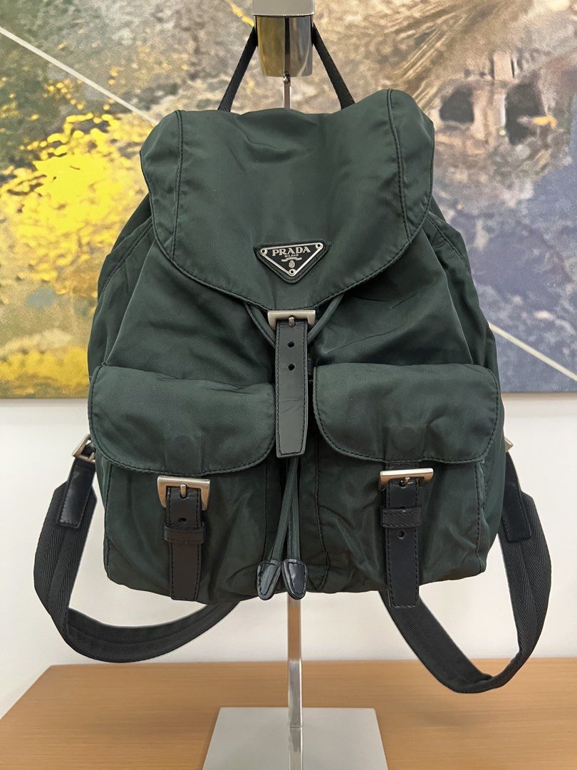 Vintage Prada Tessuto Nylon Backpack Green (Category: Backpacks) located in Manila. Submitted by pearlt455 (Listing ID 1463897950, Image 1). Description: - Authentic Vintage Prada Tessuto Nylon Backpack - Color: Dark Green - Material: Nylon with Leather Trim - Origin: Made in Italy - Closure: Drawstring with Buckle Flap - Interior: Prada logo lining - Y2K style; perfect for everyday wear .