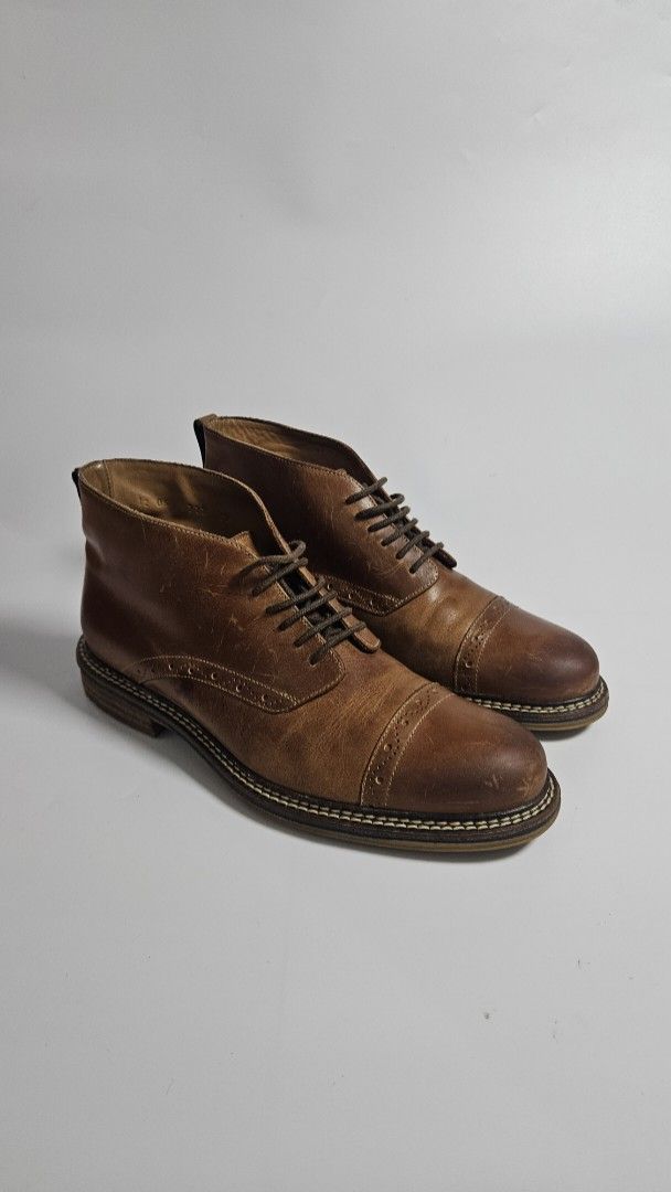 Profession Bottier Leather Cap Toe Boots (Category: Boots) located in Alfonso. Submitted by jbcamet (Listing ID 1463830863, Image 1). Description: - Brand: Profession Bottier - Material: Brown Leather - Style: Cap toe with brogue detailing - Closure: Lace-up - Condition: Soles show wear - Features: Classic look, suitable for everyday wear - Size 8 US.