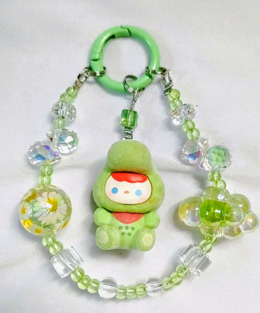 Pucky gator Popmart DIY charms (Category: Charms) located in Caloocan City. Submitted by jark_moonshop (Listing ID 1463843082, Image 1). Description: - Handmade beaded keychain - Features a cute green character charm - Clear and green beads - Includes flower and cloud charms - Green clasp for easy attachment - Ideal for bags, backpacks, or keys - Unique and charming accessory.