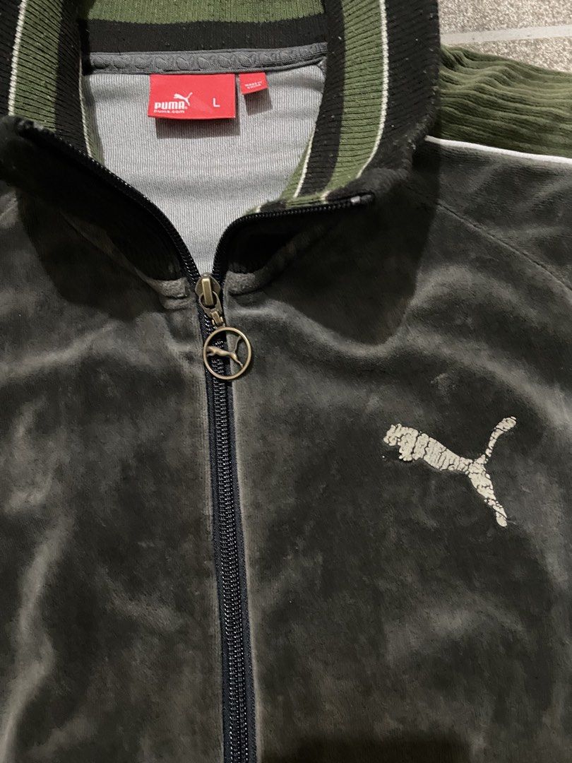 Puma Velour Track Jacket Green Size L (Category: Coats, Jackets and Outerwear) located in Manila. Submitted by yhn67 (Listing ID 1463867777, Image 2). Description: - Puma velour track jacket - Color: Dark grey/green - Embroidered classic Puma logo on chest - Ribbed collar and cuffs - Two front pockets with zip closure - Zipper pull features a Puma charm - Ideal for casual wear.