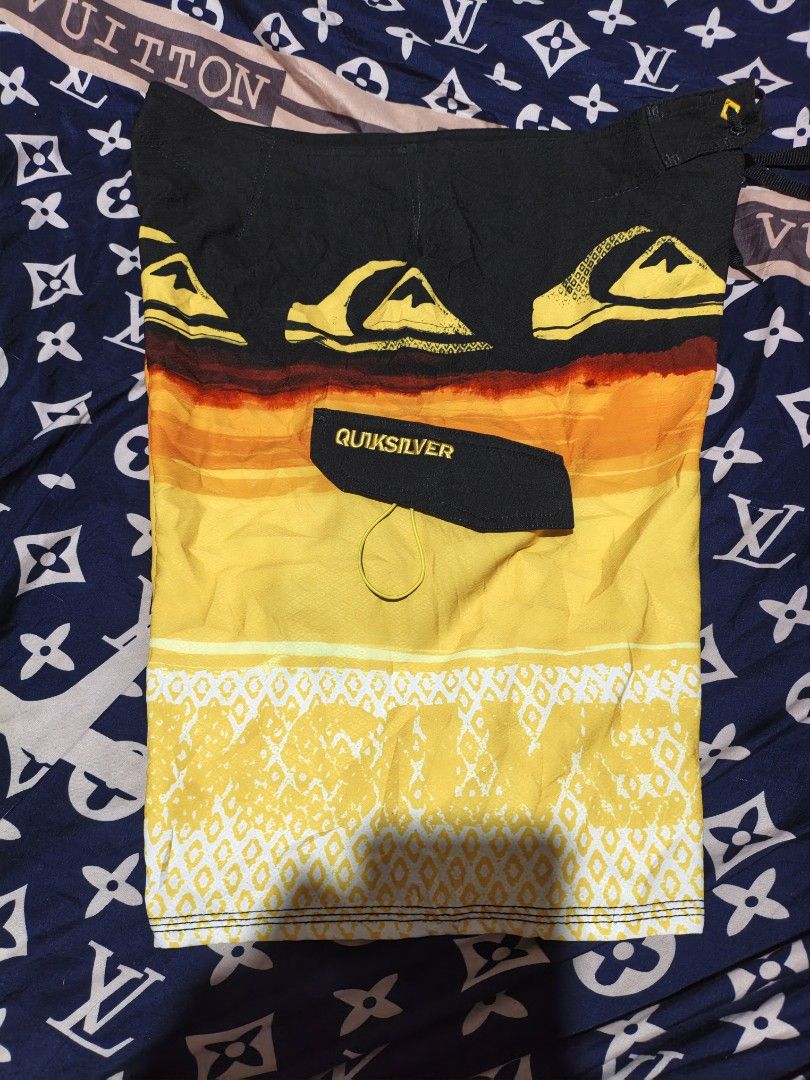 Quiksilver Board Shorts Size S (Category: Swim Trunks & Board Shorts) located in Maasim. Submitted by ukayganda25 (Listing ID 1463890862, Image 1). Description: - Quiksilver Board Shorts - Size: L - Color: Bright Yellow with Black & Orange Sunset Graphic - Material: 100% Polyester - Ideal for: Swimming, Surfing - Features: Drawstring Waist for Secure Fit, Quiksilver Logo.