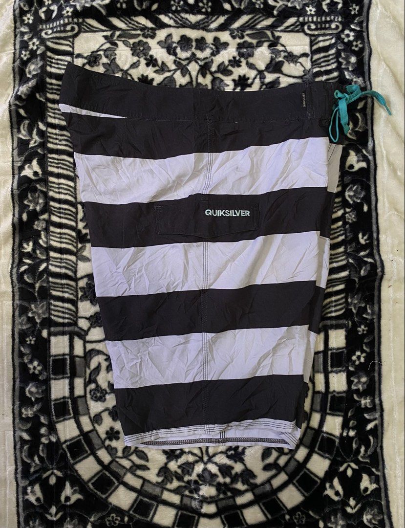Quiksilver Striped Board Shorts (Category: Swim Trunks & Board Shorts) located in Sebaste. Submitted by phak.thrifts (Listing ID 1463850023, Image 2). Description: - Brand: Quiksilver - Design: Black and white stripes - Features: Drawstring waist, back pocket - Branding: Quiksilver logo on left leg and back pocket - Origin: Made in Indonesia - Ideal for: Swimming, surfing, beach activities.