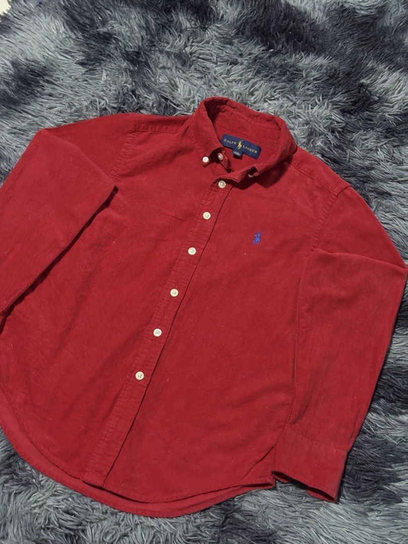 Ralph Lauren Corduroy Button Down Shirt Red (Category: Tshirts & Polo Shirts ) located in Bulacan. Submitted by luck_finds (Listing ID 1463865074, Image 2). Description: - Kids size W: 15 L: 21 - Classic red corduroy shirt from Ralph Lauren - Long sleeves with button cuffs - Iconic polo player logo embroidered on the chest - Button-down collar - Made in Indonesia - Versatile for casual or smart-casual outfits.