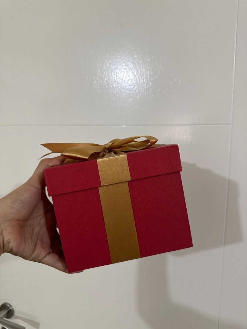 Red Gift Box with Gold or White Ribbon (Category: Storage Boxes & Baskets) located in Mandaluyong City. Submitted by lovedbyjaaaam (Listing ID 1463749353, Image 3). Description: - Set of sturdy red gift boxes - Available with gold or white ribbon options - Ideal for birthdays, holidays, and special occasions - Perfect for gift-giving or stylish storage - Boxes are empty and ready to be filled with your presents Small - 6.5x6.5x5 - 200 Medium - 8.