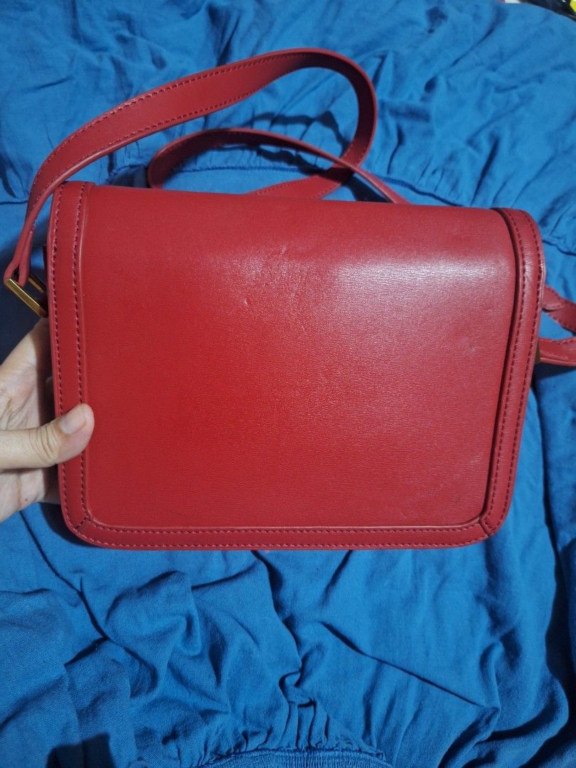 Red Leather YSL Shoulder Bag (Category: Luxury Bags & Wallets) located in Quezon City. Submitted by cloudymay (Listing ID 1463780311, Image 2). Description: - Genuine red leather shoulder bag - Iconic gold YSL logo - Adjustable strap for comfortable wear - Spotless interior lining - Versatile: perfect for day or evening use - Unique closure - Ready for its new owner!.