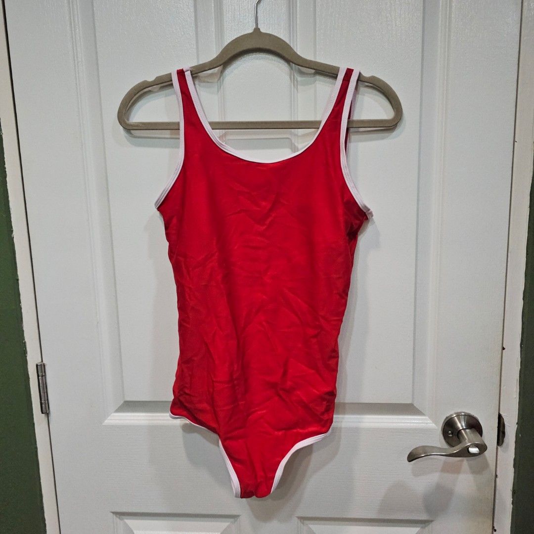 Red One-Piece Swimsuit with White Trim (Category: Bikinis & Swimsuits) located in Makati City. Submitted by goldenbird.001 (Listing ID 1463854722, Image 1). Description: - Classic red one-piece swimsuit - White trim along neckline and leg openings - Simple and timeless design - Ideal for swimming or lounging - Perfect for your next beach trip or pool day - Essential for summer fun.