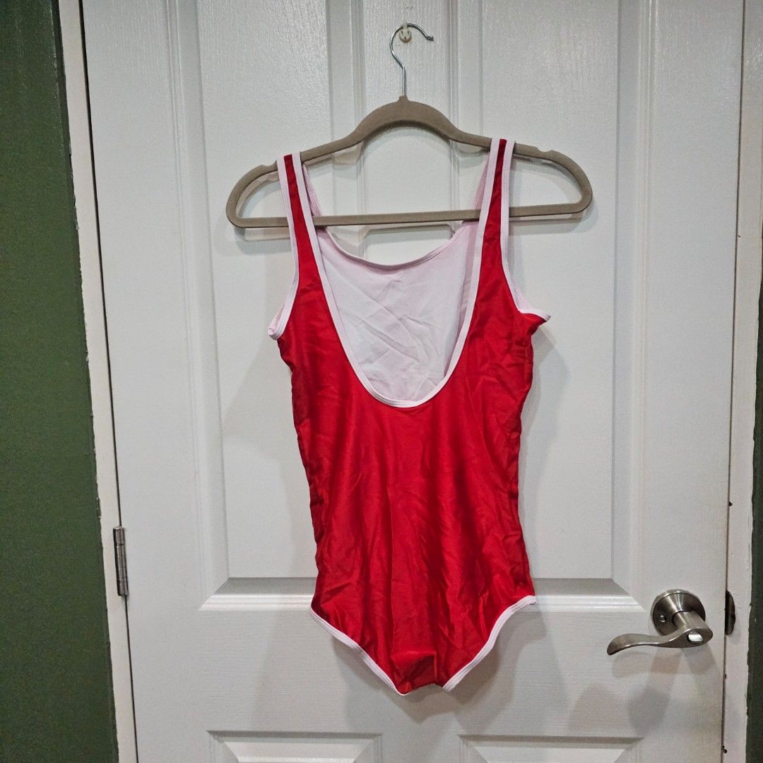 Red One-Piece Swimsuit with White Trim (Category: Bikinis & Swimsuits) located in Makati City. Submitted by goldenbird.001 (Listing ID 1463854722, Image 2). Description: - Classic red one-piece swimsuit - White trim along neckline and leg openings - Simple and timeless design - Ideal for swimming or lounging - Perfect for your next beach trip or pool day - Essential for summer fun.