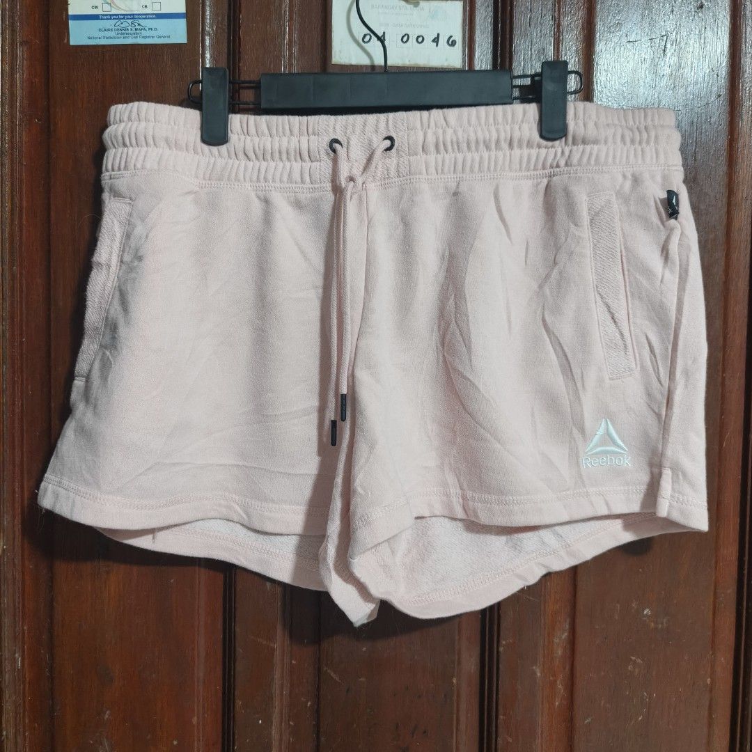 Reebok Fleece garter shorts (Category: Shorts) located in Quezon City. Submitted by makmakramirez (Listing ID 1463891775, Image 1). Description: size 32-40 length 12inches Authentic Reebok Shorts: Women's size Large (L/G/G). ​Soft & Cozy: Made from a comfortable 60% cotton, 40% polyester fleece blend. ​Pastel Pink Style: Light pink shade with a subtle Reebok logo. ​Custom Fit: Flexible elastic waistband with drawstrings. ​Practical: Features side