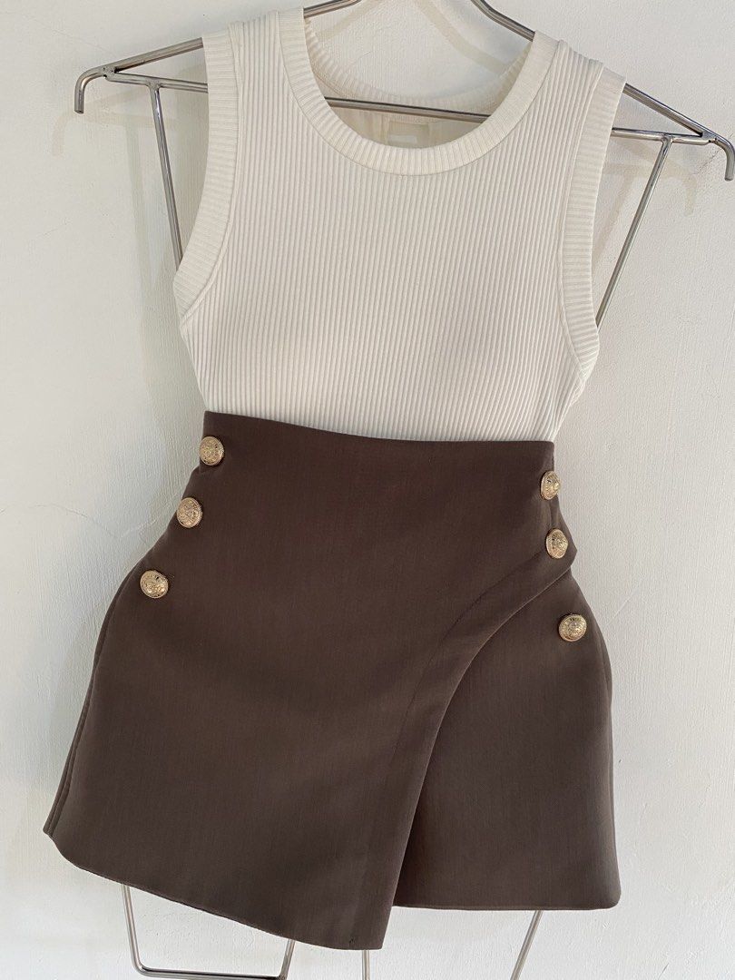 Ribbed Tank Top with Brown Button Skirt Set (Category: Sets or Coordinates) located in Vigan. Submitted by yourcloset1001 (Listing ID 1463914907, Image 3). Description: - White ribbed tank top - Brown asymmetrical skirt - Skirt has gold button details on the front - High-waisted skirt - Chic and put-together look - Suitable for casual day outs or night events - Easy to mix and match.