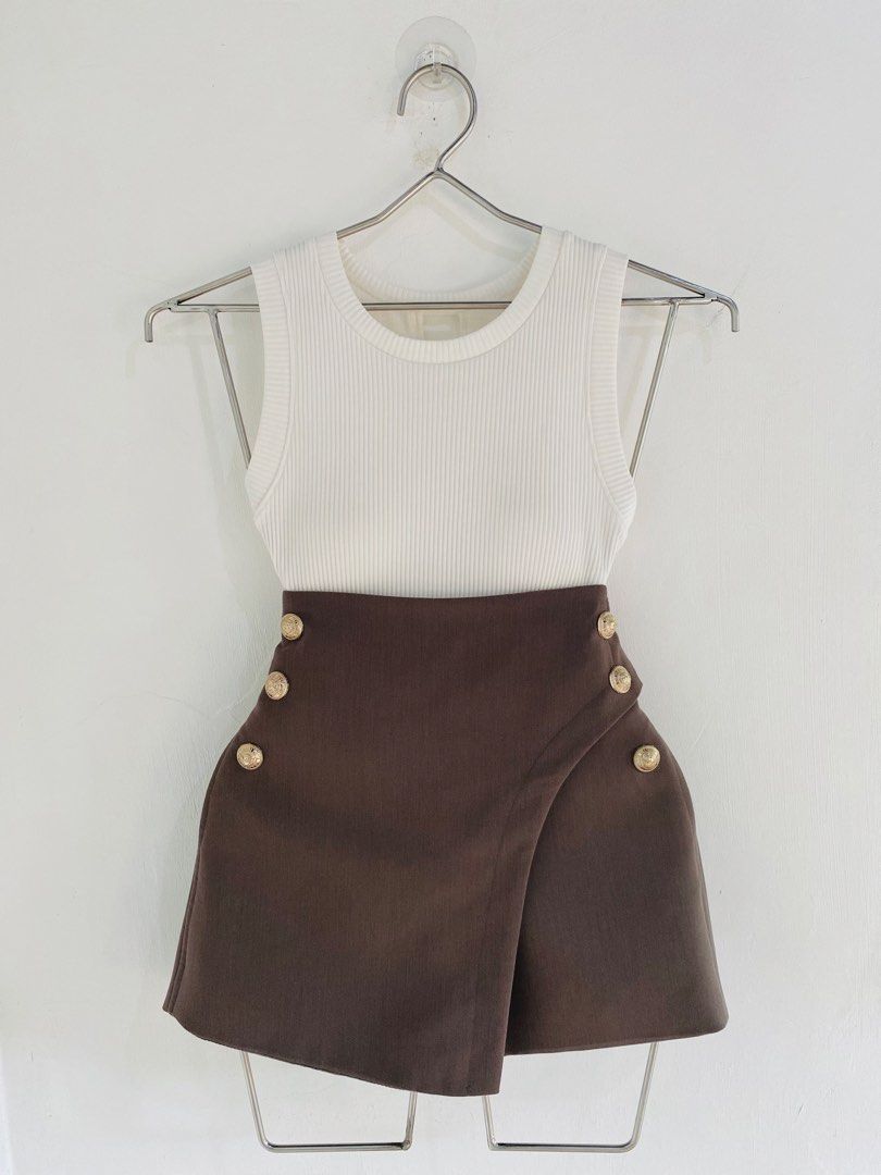 Ribbed Tank Top with Brown Button Skirt Set (Category: Sets or Coordinates) located in Vigan. Submitted by yourcloset1001 (Listing ID 1463914907, Image 1). Description: - White ribbed tank top - Brown asymmetrical skirt - Skirt has gold button details on the front - High-waisted skirt - Chic and put-together look - Suitable for casual day outs or night events - Easy to mix and match.