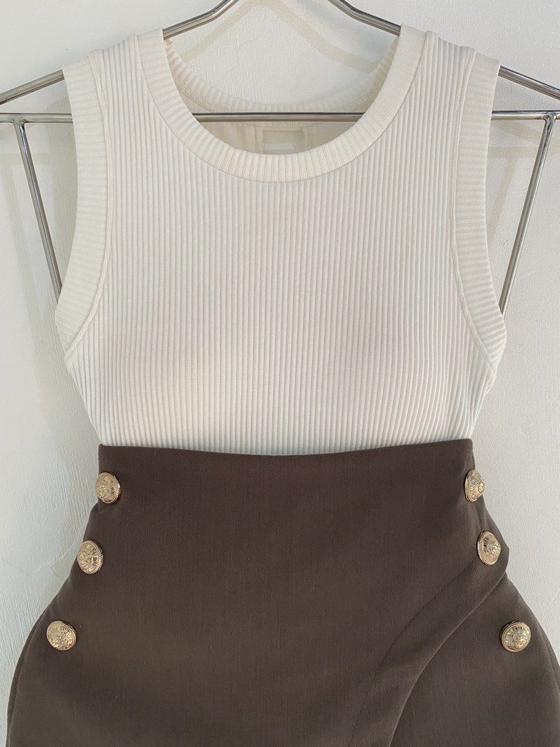 Ribbed Tank Top with Brown Button Skirt Set (Category: Sets or Coordinates) located in Vigan. Submitted by yourcloset1001 (Listing ID 1463914907, Image 2). Description: - White ribbed tank top - Brown asymmetrical skirt - Skirt has gold button details on the front - High-waisted skirt - Chic and put-together look - Suitable for casual day outs or night events - Easy to mix and match.