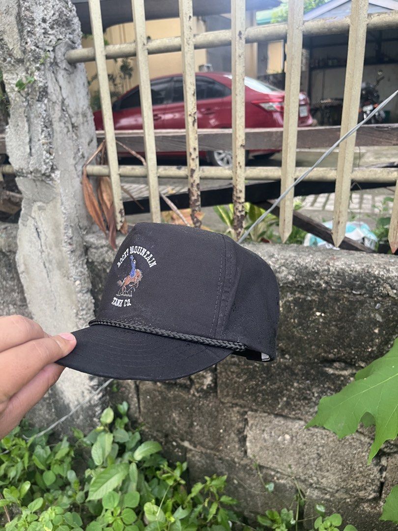 Rocky Mountain Tank Co. Black Snapback Cap (Category: Caps & Hats) located in Manila. Submitted by christian048 (Listing ID 1463834031, Image 2). Description: - Brand: Rocky Mountain Tank Co. - Color: Black - Style: Snapback cap By Youngan - Design: Embroidered logo featuring a cowboy riding a horse - Detail: Rope accent across the brim - Fit: Adjustable strap at the back, one size fits all - Occasion: Ideal for casual wear.