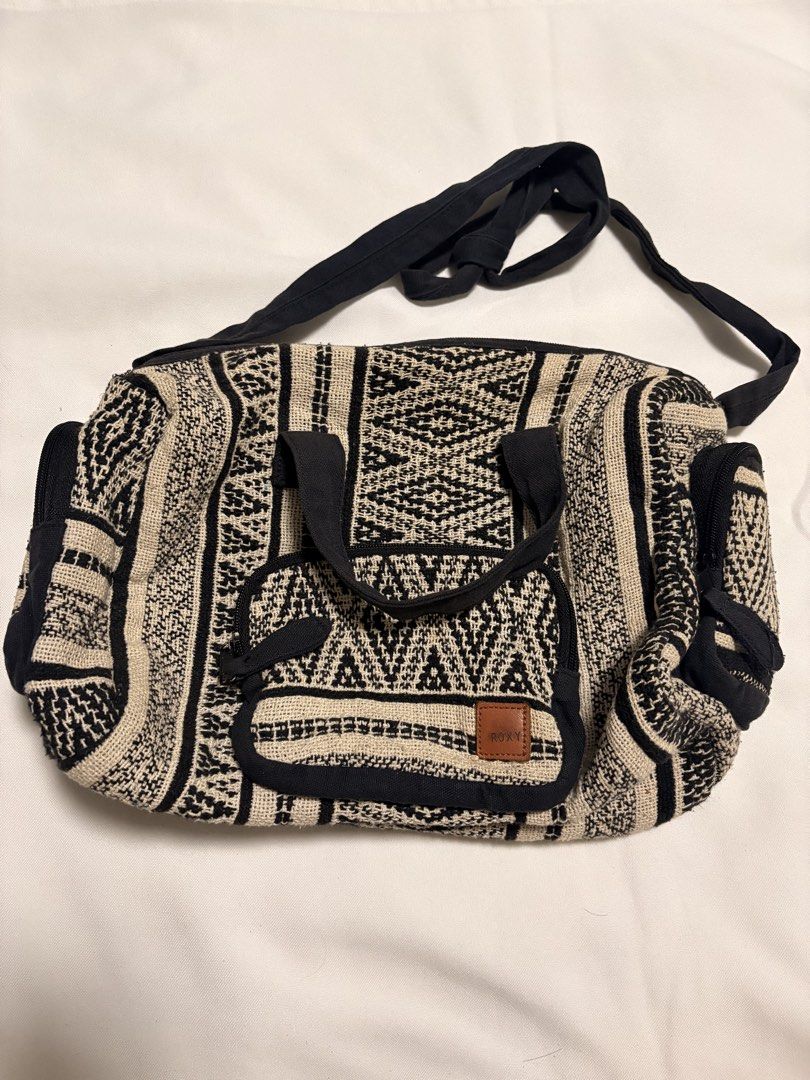 Roxy Boho Pattern Tote Bag (Category: Tote Bags) located in Mandaluyong City. Submitted by sarisaringtinda (Listing ID 1463877318, Image 1). Description: - Stylish Roxy tote bag with a black and cream boho pattern. - Two top handles and a long shoulder strap for versatile carrying. - Multiple convenient pockets on the outside. - Fully lined interior in black. - All zippers are in good working condition. - Ideal for everyday errands or your next t