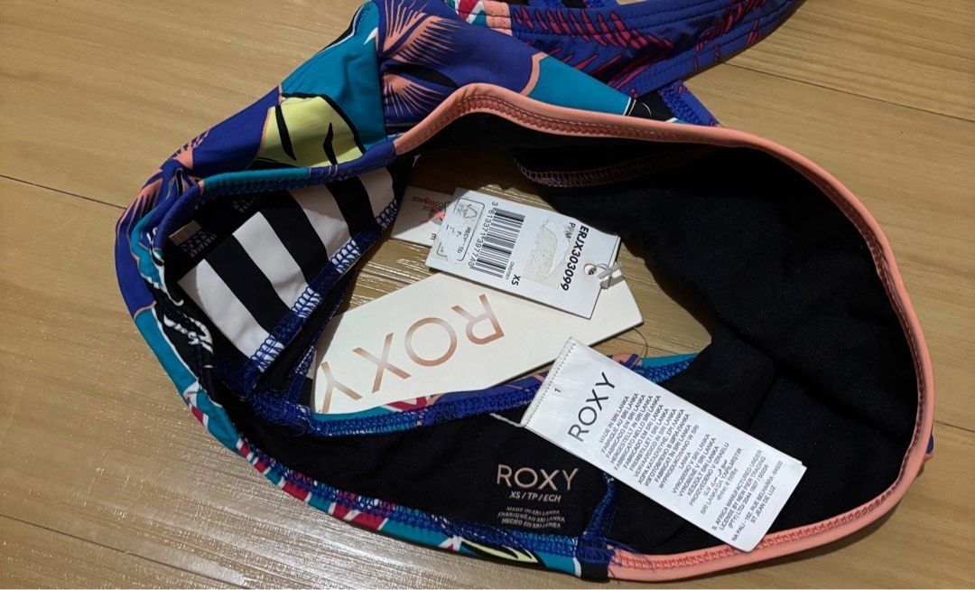 Roxy Printed/Striped Bikini Top XS (Category: Bikinis & Swimsuits) located in Quezon City. Submitted by garagesale2026 (Listing ID 1463868472, Image 3). Description: - Brand new with tag - Original from US - Ideal for kids - XS on tag, runs small, fit kids - Unique racerback design; Zipper back closure; Blue base with pink adn teal accents; Striped back detail; Coral colored detail and hem.