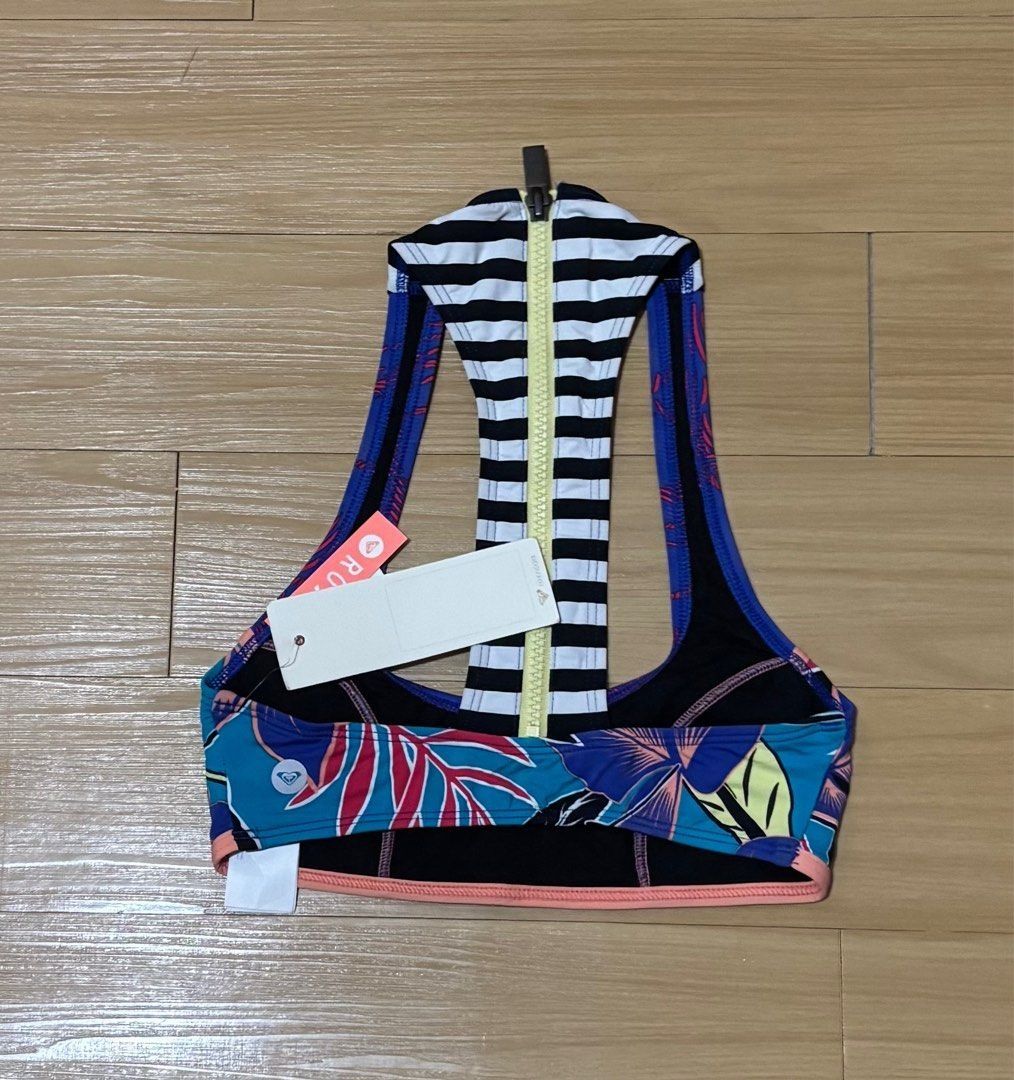 Roxy Printed/Striped Bikini Top XS (Category: Bikinis & Swimsuits) located in Quezon City. Submitted by garagesale2026 (Listing ID 1463868472, Image 2). Description: - Brand new with tag - Original from US - Ideal for kids - XS on tag, runs small, fit kids - Unique racerback design; Zipper back closure; Blue base with pink adn teal accents; Striped back detail; Coral colored detail and hem.