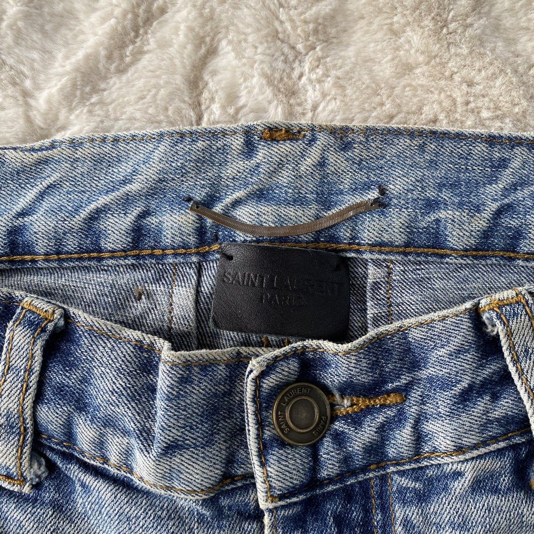 SAINT LAURENT PARIS RIPPED JEANS (Category: Luxury Apparel) located in Cadiz. Submitted by thrift_hunt_garage (Listing ID 1463883839, Image 3). Description: SAINT LAURENT PARIS RIPPED JEANS Size and measurements by inches : On tag 29 Width 30 Length 42 Rise 10 Leg opening 6 Knee 7 Thigh 9.5 Conditions and details : Ripped/Tattered factory design Wash denim Slim fit type Issue none Flaws need wash .