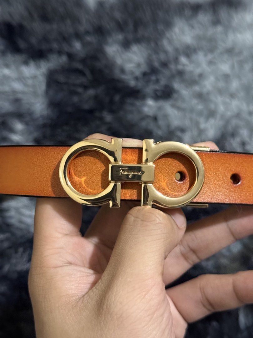 Salvatore Ferragamo Gancini Belt (Category: Belts) located in Manila. Submitted by adriyawnnn (Listing ID 1463928104, Image 3). Description: - Authentic Ferragamo orange leather belt - Iconic gold Gancini buckle with engraved logo - Classic design, suitable for casual and formal wear - Features multiple holes for adjustable sizing.