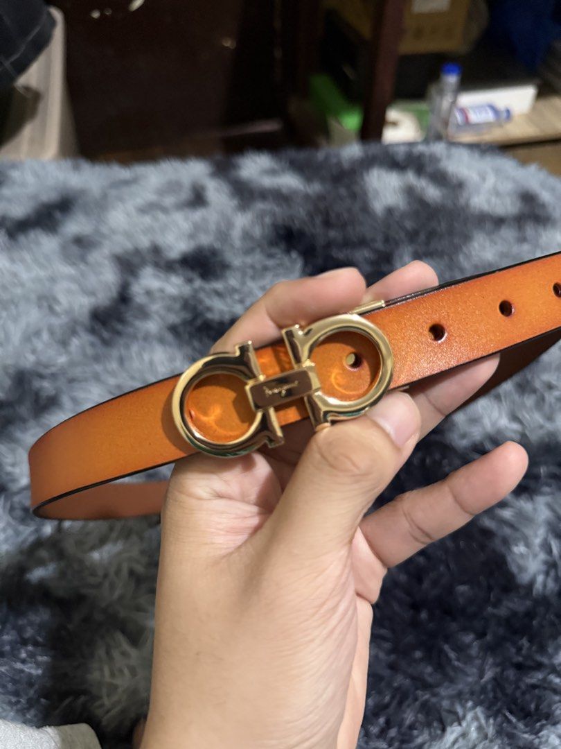 Salvatore Ferragamo Gancini Belt (Category: Belts) located in Manila. Submitted by adriyawnnn (Listing ID 1463928104, Image 2). Description: - Authentic Ferragamo orange leather belt - Iconic gold Gancini buckle with engraved logo - Classic design, suitable for casual and formal wear - Features multiple holes for adjustable sizing.