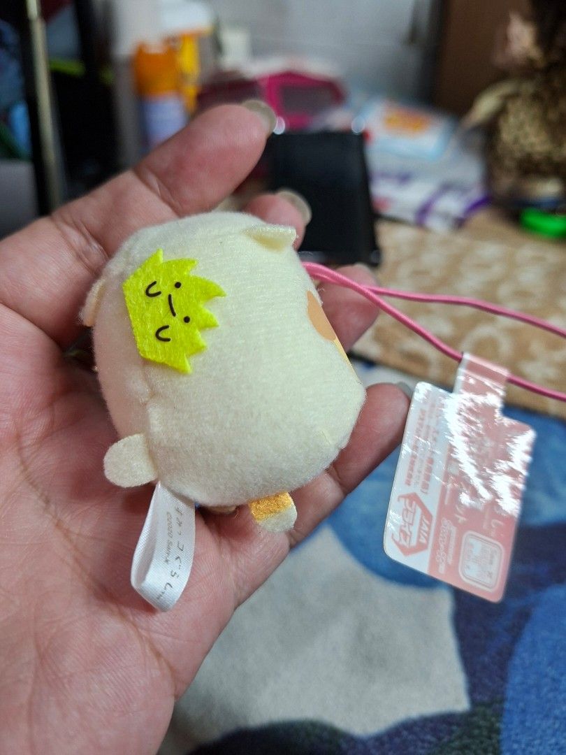 San-X Sumikko Gurashi Plush Keychain (Category: Plushies & Soft Toys) located in Lucena. Submitted by dai_suki (Listing ID 1463856361, Image 2). Description: - Adorable Sumikko Gurashi plush keychain - Features a cute yellow crown detail - Comes with a pink elastic band for easy attachment - Original tag still attached - Authentic San-X product, made in 2020.