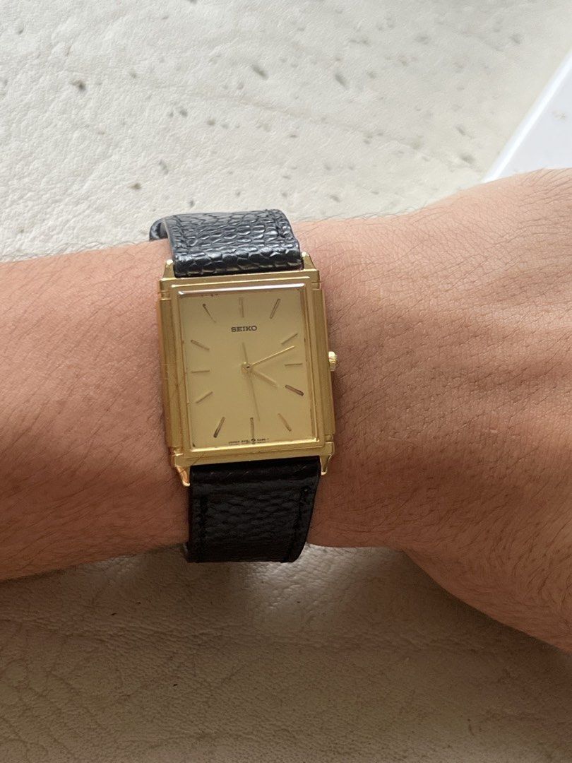 Seiko Tank (Category: Men's Watches) located in Cainta. Submitted by kylekicks99 (Listing ID 1463867716, Image 1). Description: Reference Number: 9021-5300 Movement: Seiko Quartz (Made in Japan) Case Material: Base Metal Gold-Plated Bezel, Stainless Steel Case Back Dial: Gold / Champagne with gold hands and hour markers Condition: Pre-owned vintage condition. Case and crystal are clean with minor signs of gentle wear. Keeping accurate time. Strap