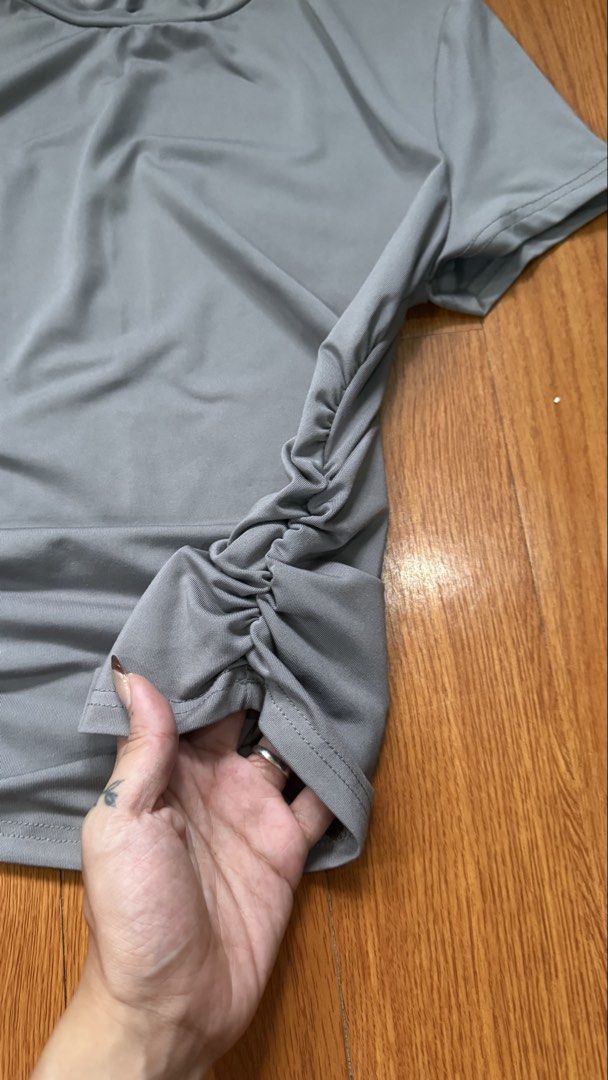 SHEIN Grey Ruched T-shirt Size S (Category: Shirts) located in Antipolo. Submitted by japanese.siomai (Listing ID 1463797525, Image 2). Description: - Brand: SHEIN - Color: Grey - Size: S - Features: Ruching detail on sides - Neckline: Crew neck - Sleeves: Short sleeves - Origin: Made in China.