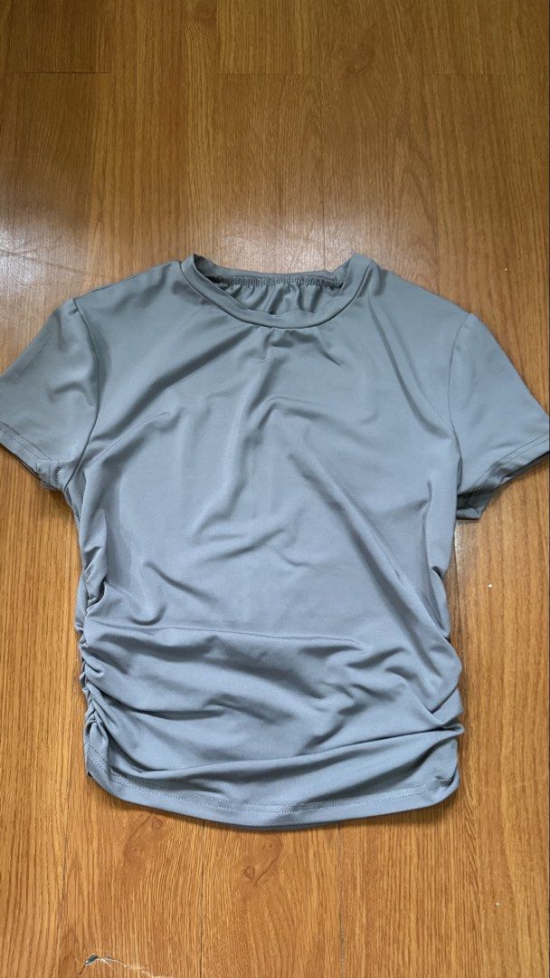 SHEIN Grey Ruched T-shirt Size S (Category: Shirts) located in Antipolo. Submitted by japanese.siomai (Listing ID 1463797525, Image 1). Description: - Brand: SHEIN - Color: Grey - Size: S - Features: Ruching detail on sides - Neckline: Crew neck - Sleeves: Short sleeves - Origin: Made in China.