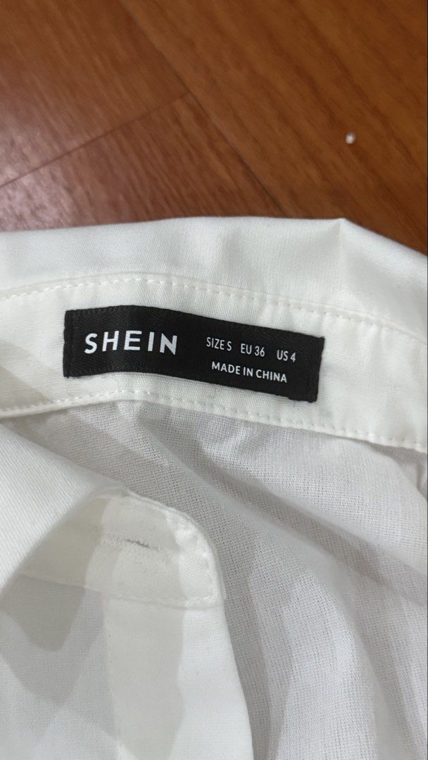 SHEIN White Cropped Button-Up Shirt Size S (Category: Shirts) located in Antipolo. Submitted by japanese.siomai (Listing ID 1463795924, Image 2). Description: - White cropped shirt from SHEIN - Size S - Button-up front with collar - Long sleeves with button cuffs - Raw hem detail - Versatile for layering or wearing solo.