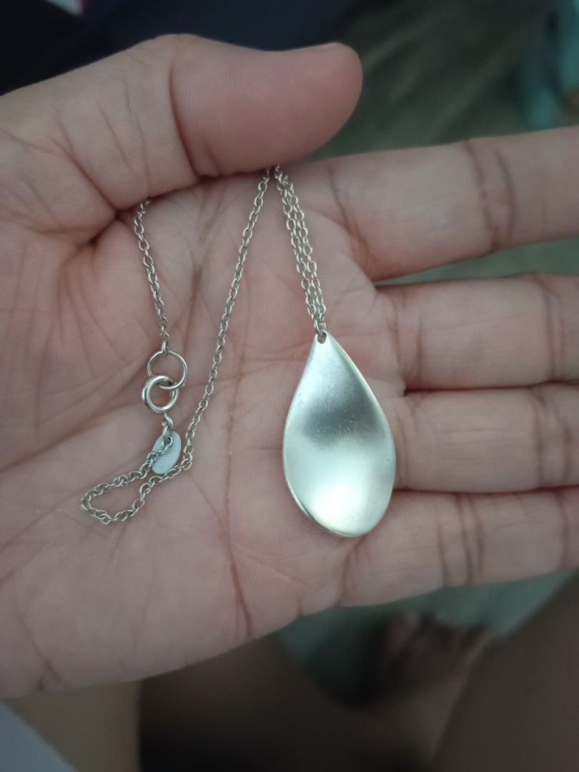 Silver Chain Necklace with Teardrop Pendant (Category: Necklaces) located in Manila. Submitted by clover_co. (Listing ID 1456208154, Image 3). Description: - Simple silver chain necklace - Features a long, thin chain - Adorned with a teardrop-shaped pendant - Clasp includes a small logo tag - Ideal for everyday wear or layering - Adjustable length for a perfect fit.