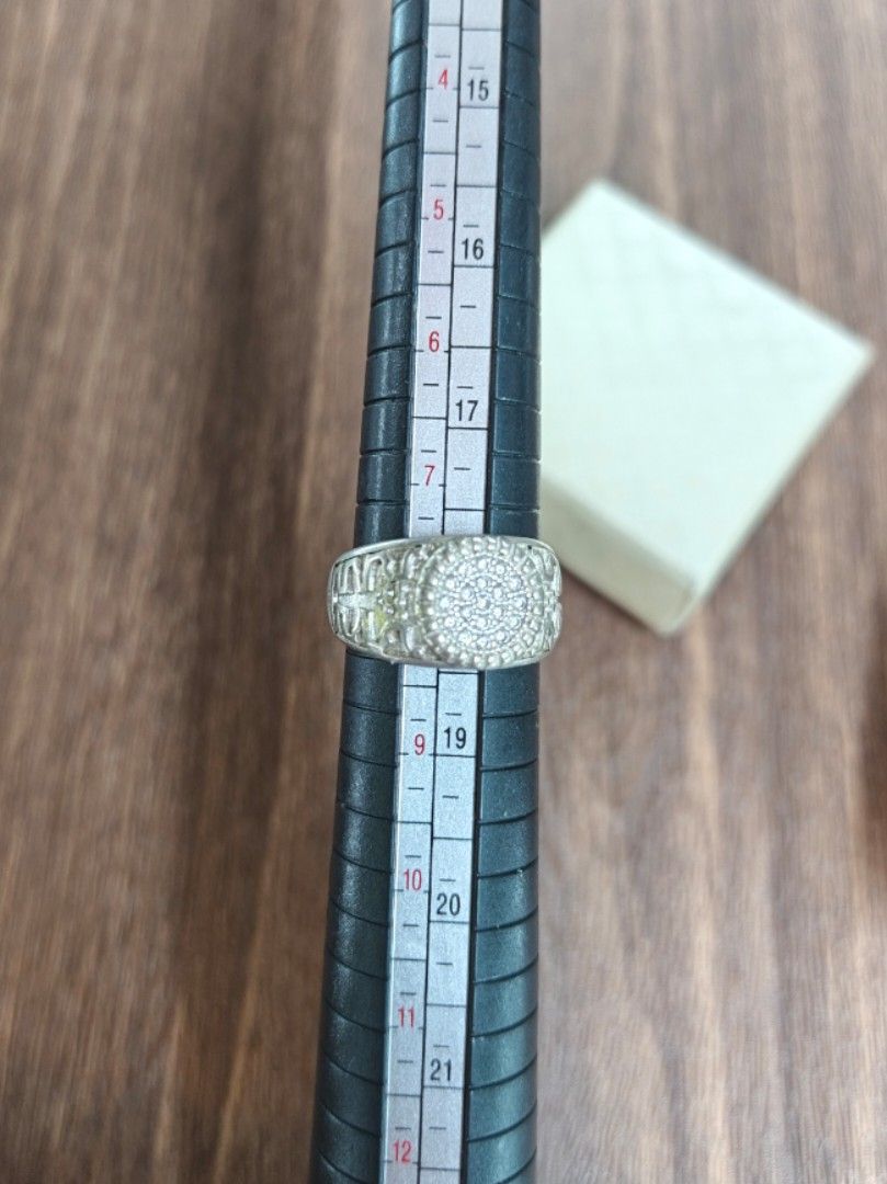 Silver Ring with Pave Set Stones (Category: Rings) located in Naga. Submitted by esteemed_shop (Listing ID 1463784008, Image 3). Description: - Elegant silver ring - Features numerous small, closely set stones - Textured design on the sides of the band - Approximately ring size 7 - Includes a small presentation box.