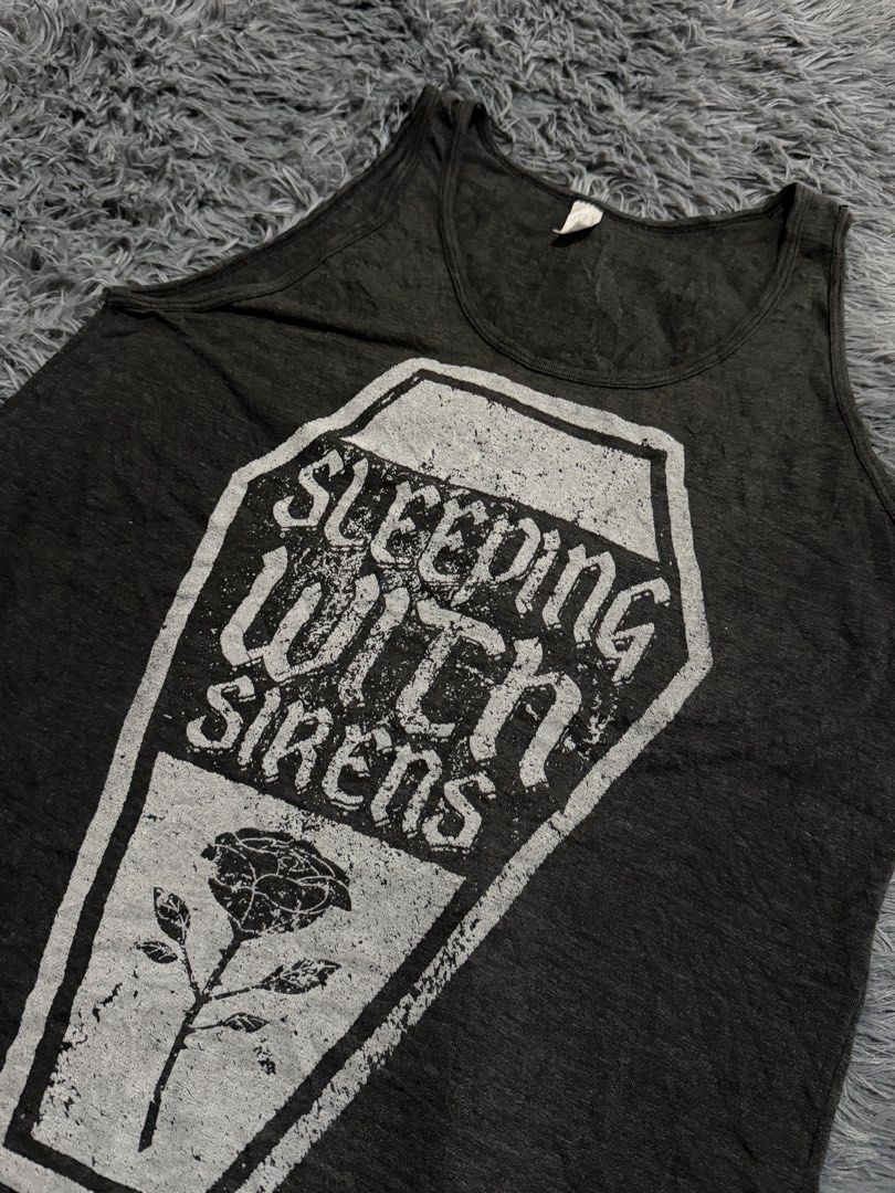 Sleeping With Sirens Coffin Rose Tank Top (Category: Sleeveless) located in Legazpi City. Submitted by loperareyn47227 (Listing ID 1463834222, Image 1). Description: - Dark grey tank top - Graphic print: Coffin and rose with 'Sleeping With Sirens' text - Estimated size: Medium (M) based on tag - Ideal for fans of the band Sleeping With Sirens 19x27.
