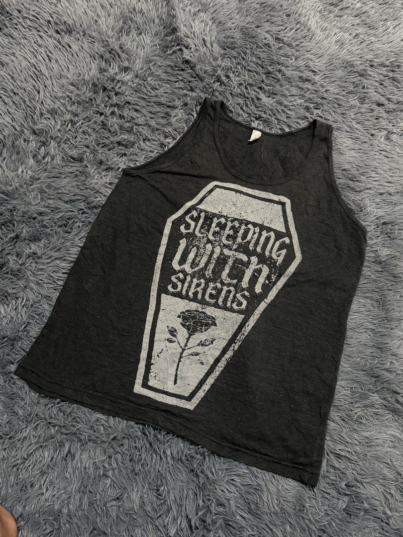 Sleeping With Sirens Coffin Rose Tank Top (Category: Sleeveless) located in Legazpi City. Submitted by loperareyn47227 (Listing ID 1463834222, Image 2). Description: - Dark grey tank top - Graphic print: Coffin and rose with 'Sleeping With Sirens' text - Estimated size: Medium (M) based on tag - Ideal for fans of the band Sleeping With Sirens 19x27.