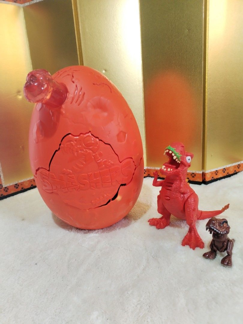 Smashers Dino Surprise Egg with Dinosaur Figures (Category: Kids Toys) located in La Trinidad. Submitted by malditas (Listing ID 1463816382, Image 2). Description: - Fun dinosaur surprise egg set - Includes 1 large red smashable egg - Comes with many small dinosaur figures inside - Some dinosaurs still in original packaging - Encourages imaginative play - Perfect for dinosaur enthusiasts - Get ready for a prehistoric adventure! From HT box BUY AS