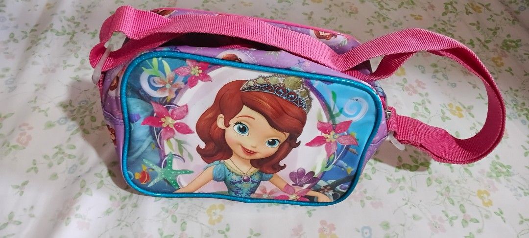 Sofia the First Kids Shoulder Bag (Category: Babies & Kids Fashion) located in Quezon City. Submitted by bagotluma (Listing ID 1463746100, Image 1). Description: Sofia the First shoulder bag for kids Features a vibrant Sofia print Adjustable strap with buckle for a comfortable fit Secure zipper closure to keep belongings safe Bright pink interior lining Ideal for carrying small toys, snacks, or other essentials *item in good condition *no return 