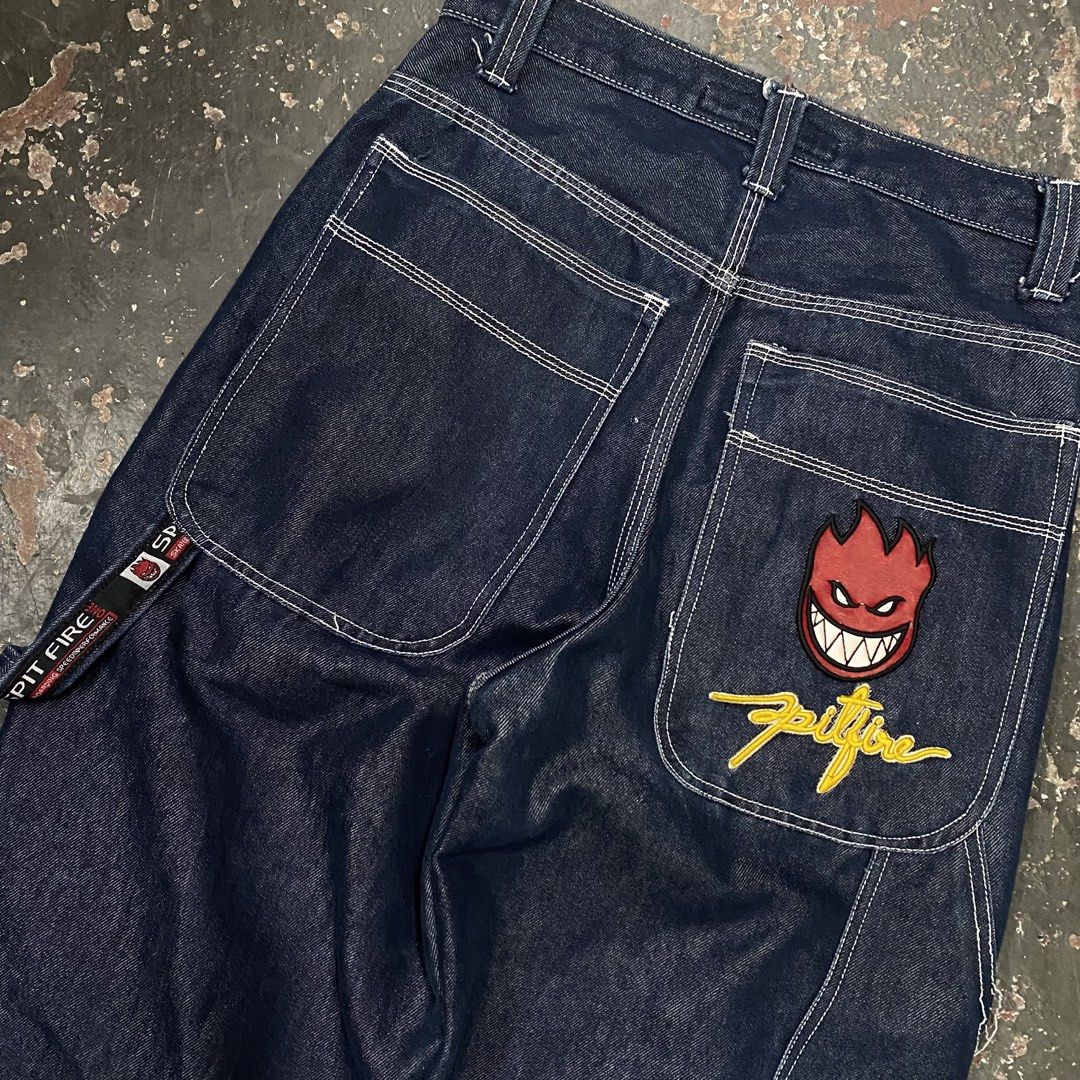 Spitfire Jeans Denim Carpenter Pants (Category: Jeans) located in Cagayan de Oro. Submitted by sumamestreethub (Listing ID 1463872337, Image 3). Description: - Spitfire dark wash denim carpenter pants - Iconic Spitfire Bighead logo embroidered on front left thigh and back right pocket - Classic five-pocket styling - Functional hammer loop on the side - Relaxed fit, ideal for skating and casual wear - White contrast stitching throughout.