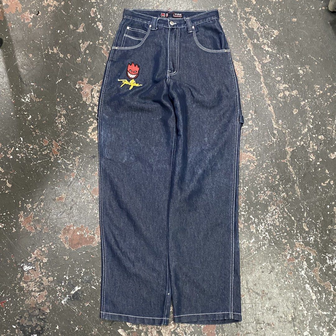 Spitfire Jeans Denim Carpenter Pants (Category: Jeans) located in Cagayan de Oro. Submitted by sumamestreethub (Listing ID 1463872337, Image 2). Description: - Spitfire dark wash denim carpenter pants - Iconic Spitfire Bighead logo embroidered on front left thigh and back right pocket - Classic five-pocket styling - Functional hammer loop on the side - Relaxed fit, ideal for skating and casual wear - White contrast stitching throughout.