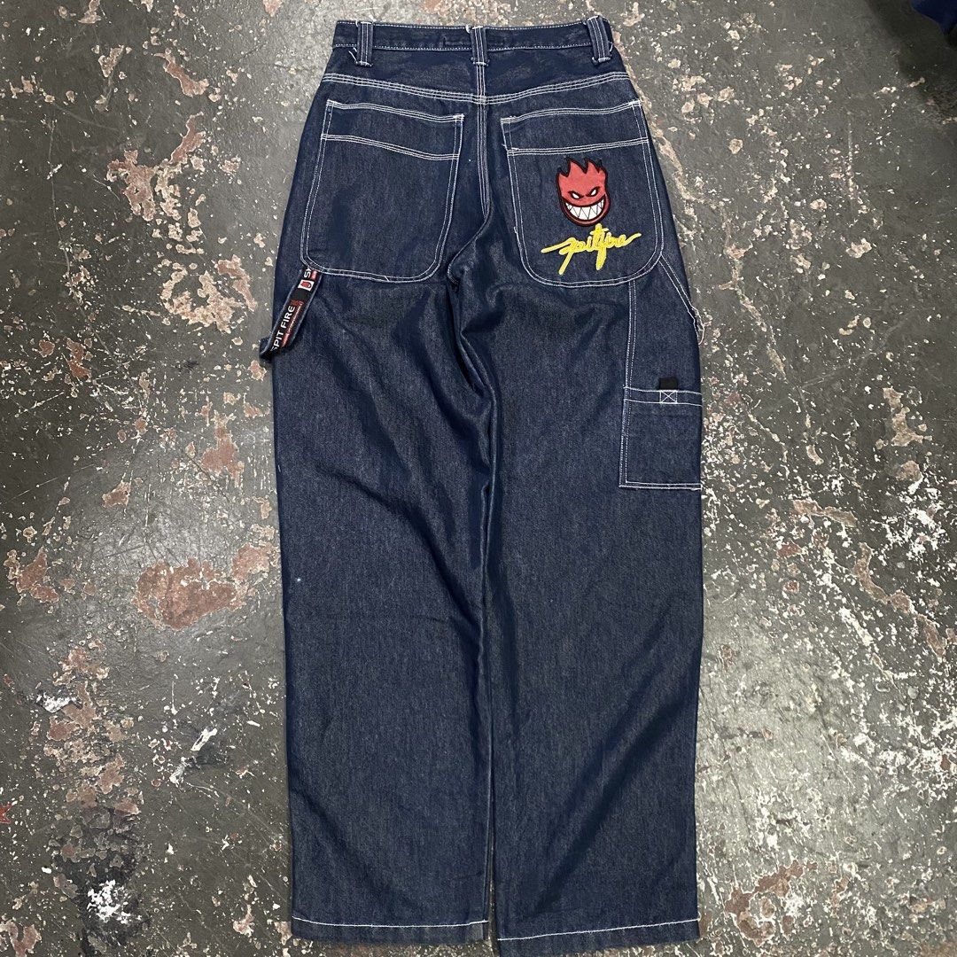 Spitfire Jeans Denim Carpenter Pants (Category: Jeans) located in Cagayan de Oro. Submitted by sumamestreethub (Listing ID 1463872337, Image 1). Description: - Spitfire dark wash denim carpenter pants - Iconic Spitfire Bighead logo embroidered on front left thigh and back right pocket - Classic five-pocket styling - Functional hammer loop on the side - Relaxed fit, ideal for skating and casual wear - White contrast stitching throughout.