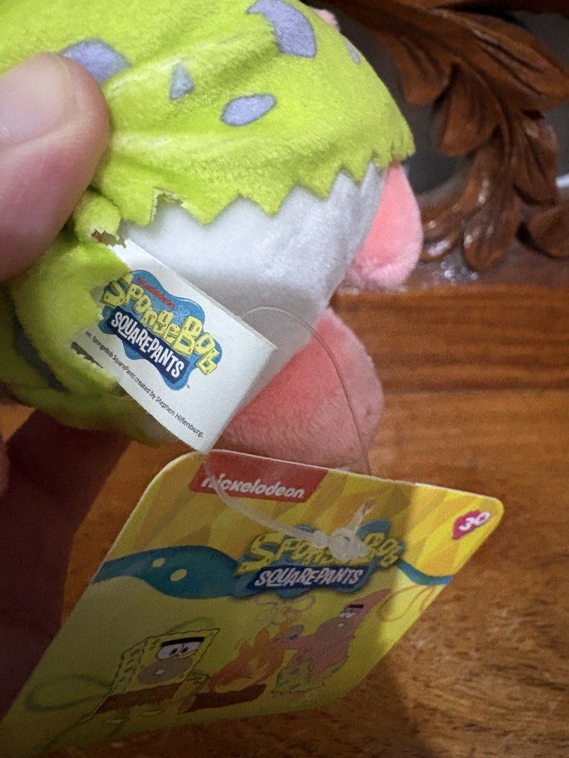 SpongeBob SquarePants Patrick Star Plush Keychain (Category: Plushies & Soft Toys) located in Quezon City. Submitted by rxyel (Listing ID 1463804374, Image 2). Description: - Adorable Patrick Star plush keychain - Features Patrick in his classic caveman outfit - Comes with original tags attached - Ideal collectible for SpongeBob SquarePants fans - Perfect for attaching to bags, keys, or backpacks - Adds a fun touch to your everyday items.