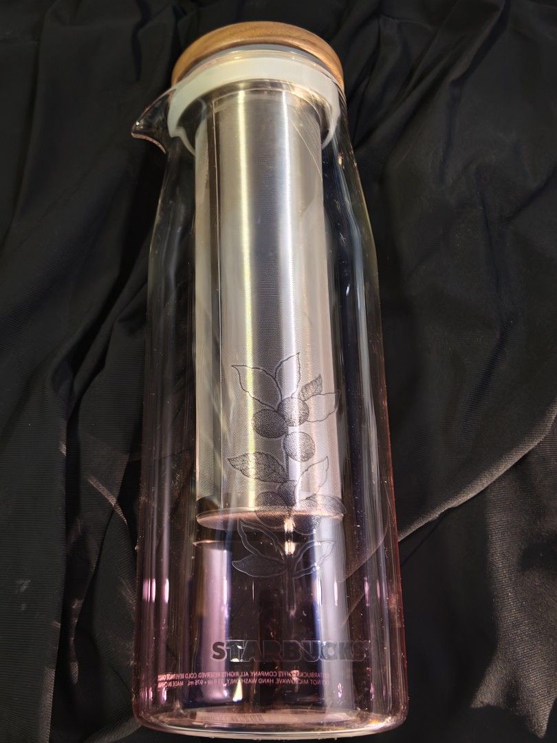 Starbucks Glass Cold Brew Coffee Tea Maker with Infuser (Category: Water Bottles & Tumblers) located in Taytay. Submitted by renz52 (Listing ID 1463836401, Image 2). Description: - Starbucks Glass Cold Brew Maker - Includes Stainless Steel Infuser - Elegant Wooden Lid - Subtle Pink Gradient Glass - Etched Coffee Plant Design - Ideal for Iced Coffee & Tea - Simple to Use and Clean New and unused condition Only 1 piece available Selling for Php 150