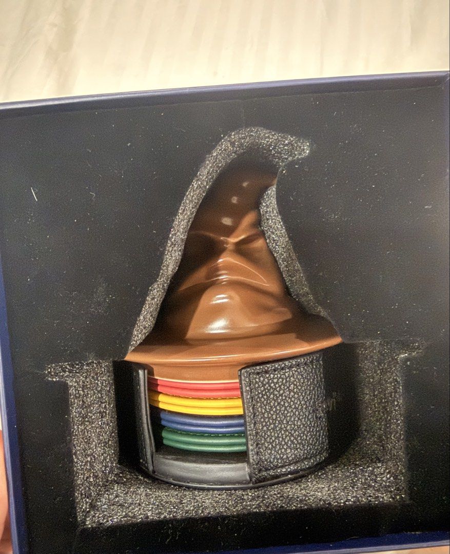 Starbucks Harry Potter Sorting Hat Coaster Set (Category: Coffee & Tea Tableware) located in Paranaque City. Submitted by mrschuadeclutter (Listing ID 1463787646, Image 2). Description: - Starbucks Harry Potter Coaster Set - Features iconic Sorting Hat design - Includes 4 coasters, one for each Hogwarts house: Gryffindor, Hufflepuff, Ravenclaw, and Slytherin - Comes in a beautiful presentation box - Ideal gift for any Harry Potter enthusiast or c