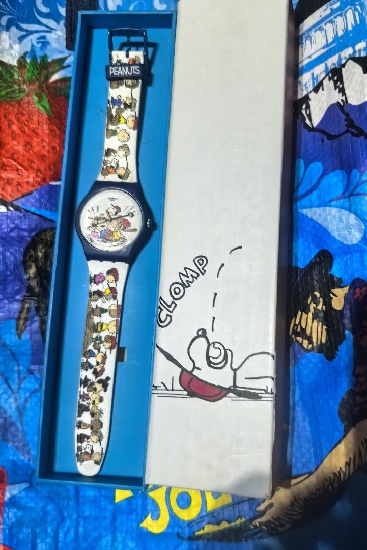 Swatch Peanuts "Time to Play" Watch (Category: Women's Watches) located in Quezon City. Submitted by uptrendglam (Listing ID 1463865178, Image 3). Description: - Swatch watch featuring the Peanuts gang playing baseball. - Panoramic strap design with all the characters. - Watch face shows Charlie Brown and the team in action. - Includes original box with "Clomp" Snoopy illustration. - Perfect collectible for any Peanuts enthusiast. -Minor chip on 