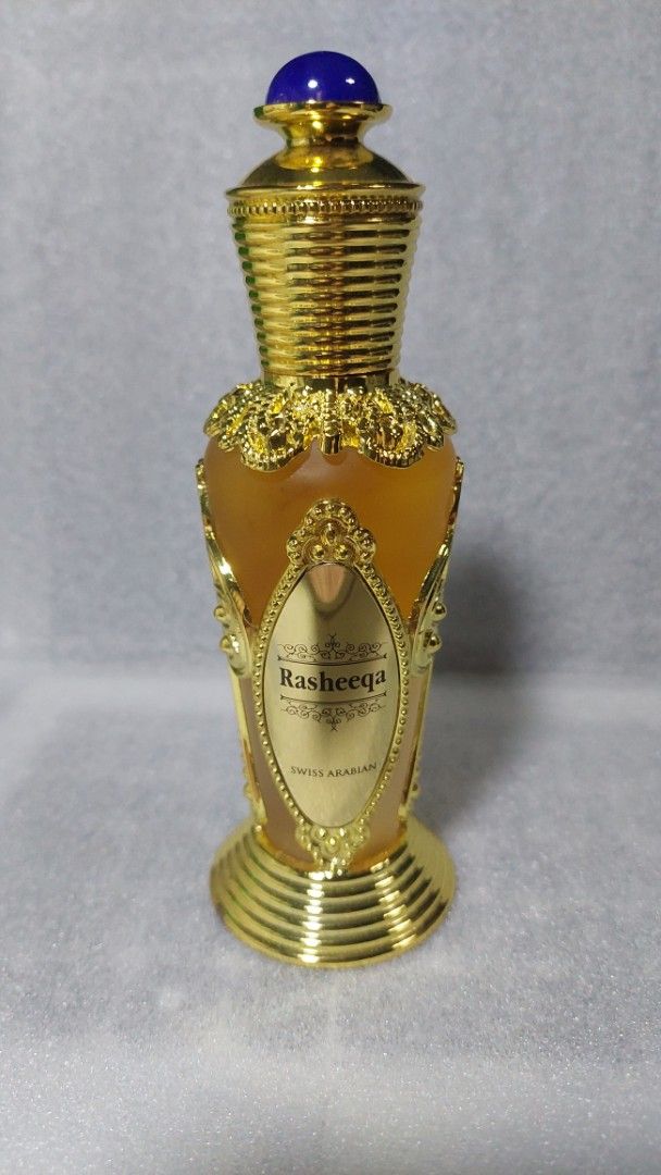 Swiss Arabian Rasheeqa Perfume (Category: Fragrance & Deodorants) located in Paranaque City. Submitted by justcody (Listing ID 1463928057, Image 1). Description: With box, 2-3 sprays missing - Stunning ornate gold perfume bottle - Filled with beautiful amber-colored liquid - Features a captivating blue gem on the cap - Includes a convenient spray nozzle - Ideal for both display and personal use - A unique addition to any collection I DON'T USE NO