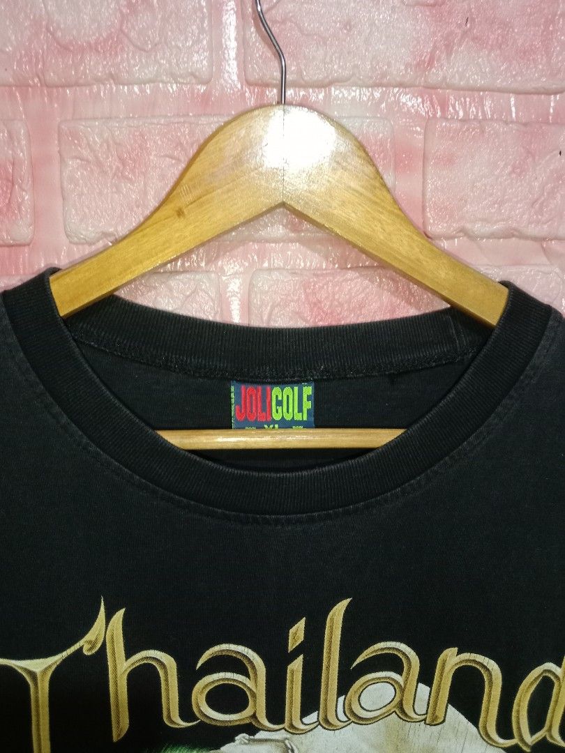 Thailand Bootleg Elephant (Category: Tshirts & Polo Shirts ) located in Davao. Submitted by ayeeasyshop13 (Listing ID 1463895143, Image 2). Description: That's a vintage black Joligolf souvenir t-shirt from Thailand featuring a large graphic of an elephant standing over a soccer ball. Very good condition Issue minimal hairline Size XL on tag Dimension 24/30 350 + SF.