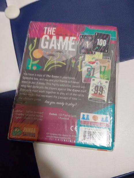 The Game Board Game by Pandasaurus Games (Category: Board Games & Puzzles) located in Quezon City. Submitted by susmaryosep1 (Listing ID 1463853388, Image 2). Description: - The Game: Cooperative card game - Players: 1-5 - Gameplay: Work together against the game itself - Features: Highly addictive, award-winning - Contents: 102 playing cards, rulebook - Ideal for: Game nights 500.
