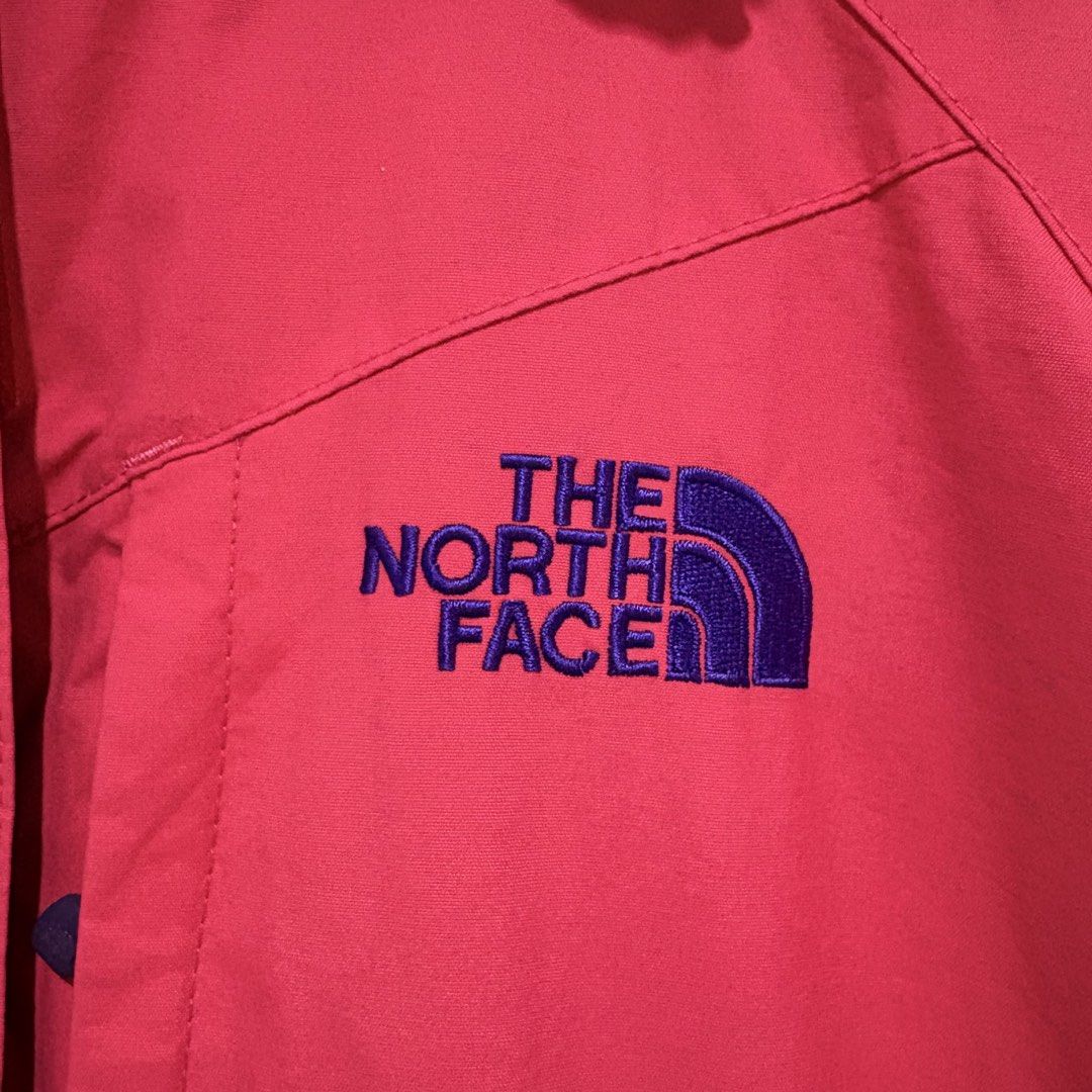 The North Face Pink Hooded Rain Jacket (Category: Coats, Jackets and Outerwear) located in Dapitan. Submitted by payt3es_thrift. (Listing ID 1463750783, Image 2). Description: - Pink rain jacket from The North Face - Blue hood lining and zipper trim - Two front pockets with zipper closures - Lightweight and packable design - Ideal for outdoor activities or daily use - Note: Shows some signs of wear on the inside lining.