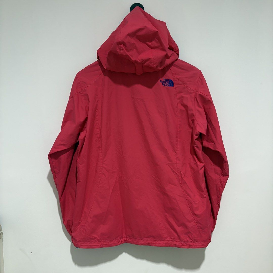 The North Face Pink Hooded Rain Jacket (Category: Coats, Jackets and Outerwear) located in Dapitan. Submitted by payt3es_thrift. (Listing ID 1463750783, Image 3). Description: - Pink rain jacket from The North Face - Blue hood lining and zipper trim - Two front pockets with zipper closures - Lightweight and packable design - Ideal for outdoor activities or daily use - Note: Shows some signs of wear on the inside lining.