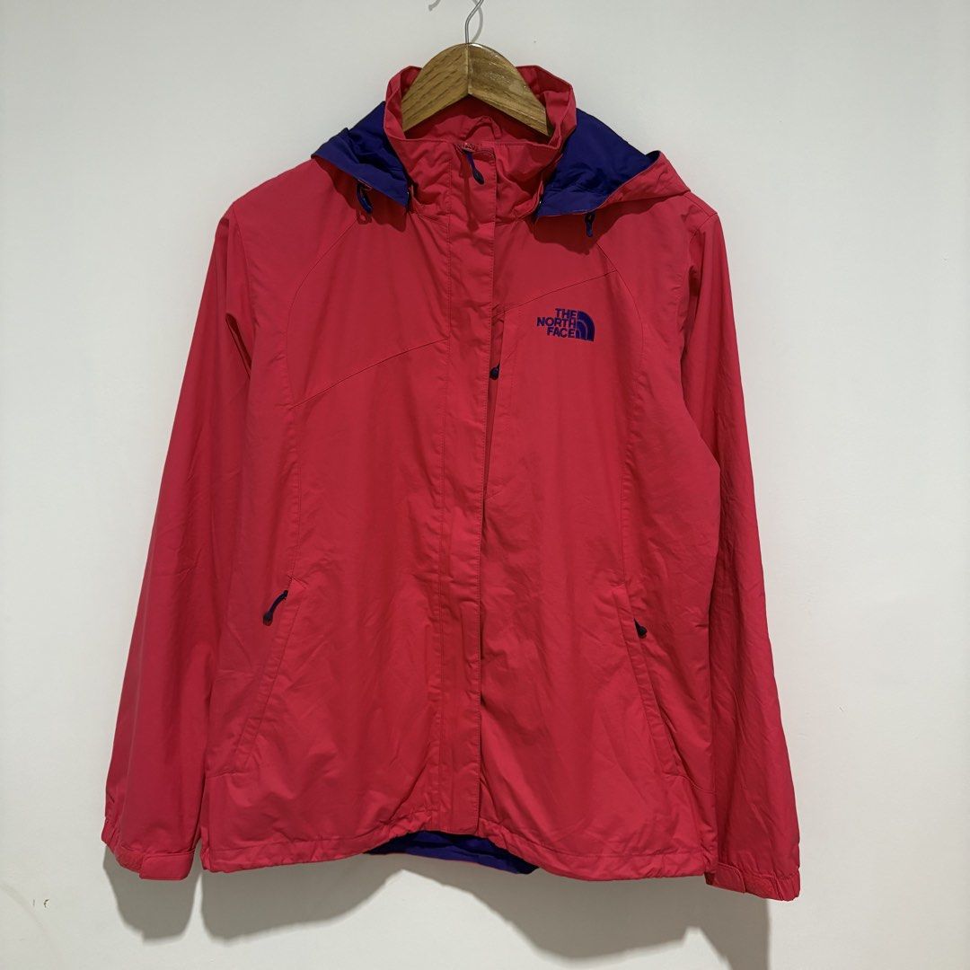 The North Face Pink Hooded Rain Jacket (Category: Coats, Jackets and Outerwear) located in Dapitan. Submitted by payt3es_thrift. (Listing ID 1463750783, Image 1). Description: - Pink rain jacket from The North Face - Blue hood lining and zipper trim - Two front pockets with zipper closures - Lightweight and packable design - Ideal for outdoor activities or daily use - Note: Shows some signs of wear on the inside lining.