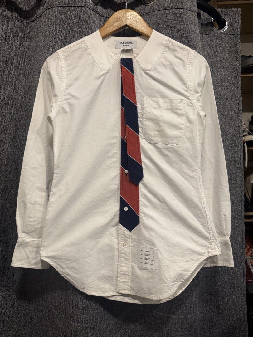 Thom Browne (Category: Longsleeves) located in Quezon City. Submitted by macleen17 (Listing ID 1463832963, Image 1). Description: Thom browne Size 40 Excellent Condition White color Necktie design iconic Color of thom browne Made in italy.