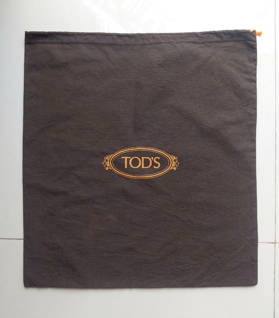 TOD'S Brown Dust Bag (Category: Craft Supplies & Tools) located in Lapu Lapu. Submitted by agnesapm_29813 (Listing ID 1463885034, Image 2). Description: - Authentic TOD'S dust bag - Color: Brown fabric with gold TOD'S logo - Dimensions: Approximately 16.5 inches wide x 18 inches tall - Perfect for storing shoes or small bags - Condition: Clean and ready for a new home - Protect your valuable items.